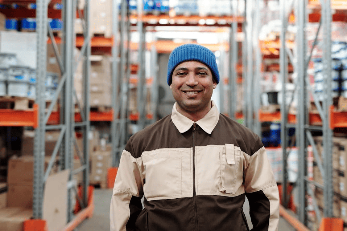 logistics worker in the warehouse smiling to the camera