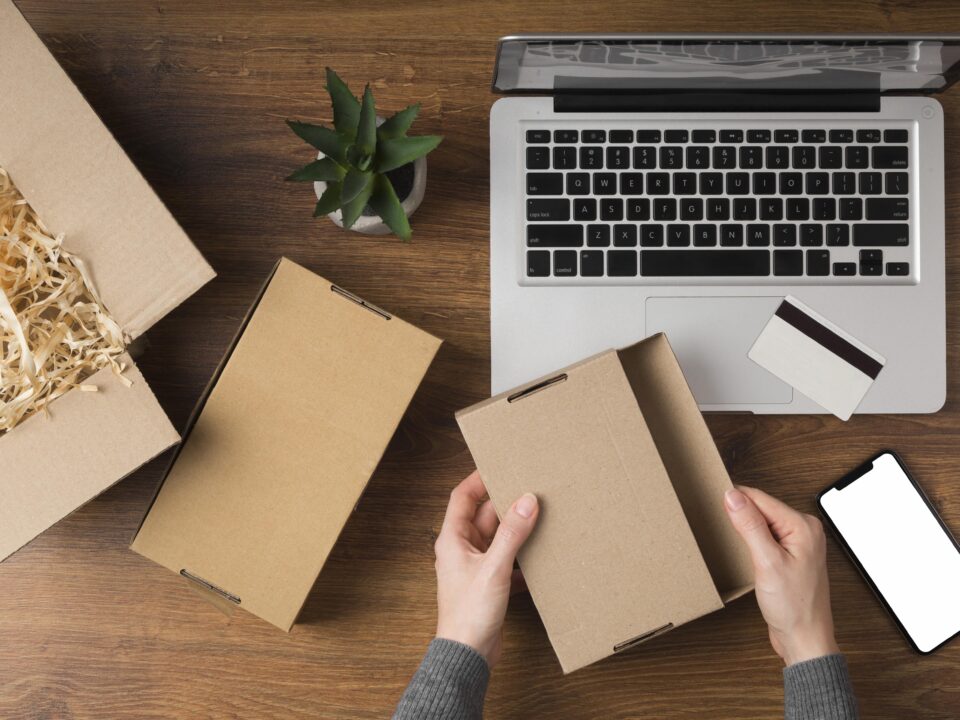 Hands preparing packages for shipping
