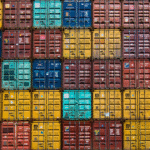very big metal containers stacked on eachother awaiting transportation