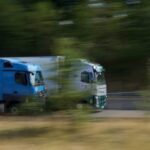 two trucks driving side by side