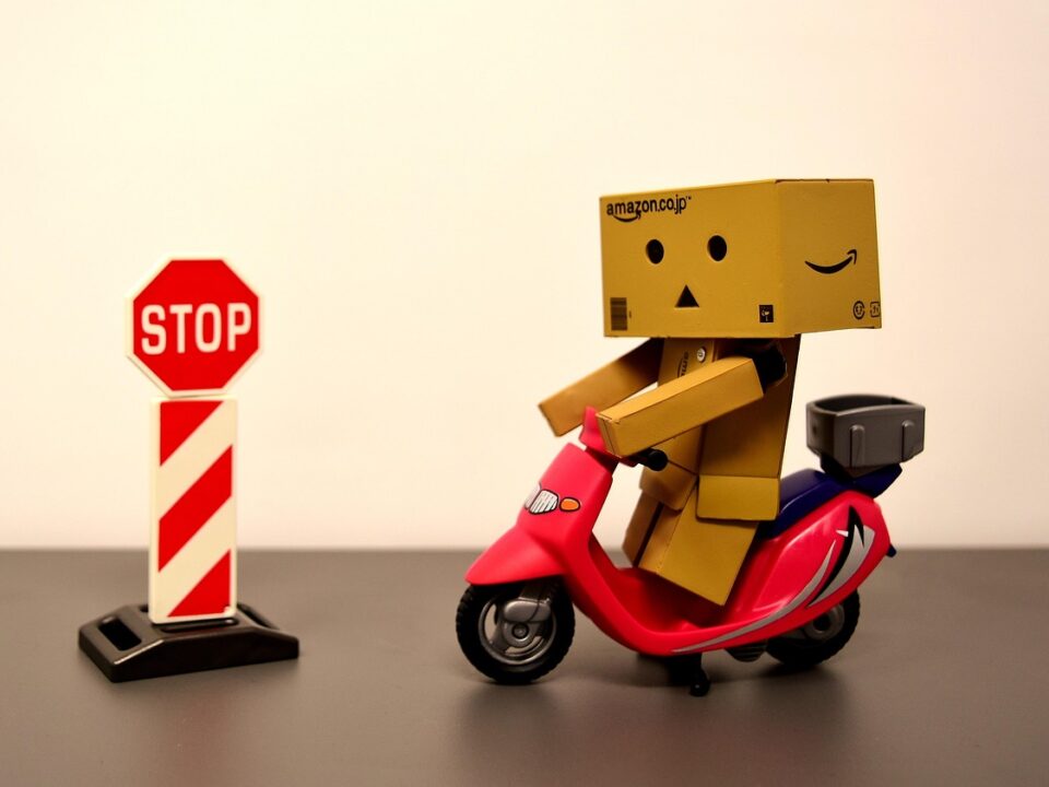 A cartoon character on a motorcycle stops at a “STOP” sign.