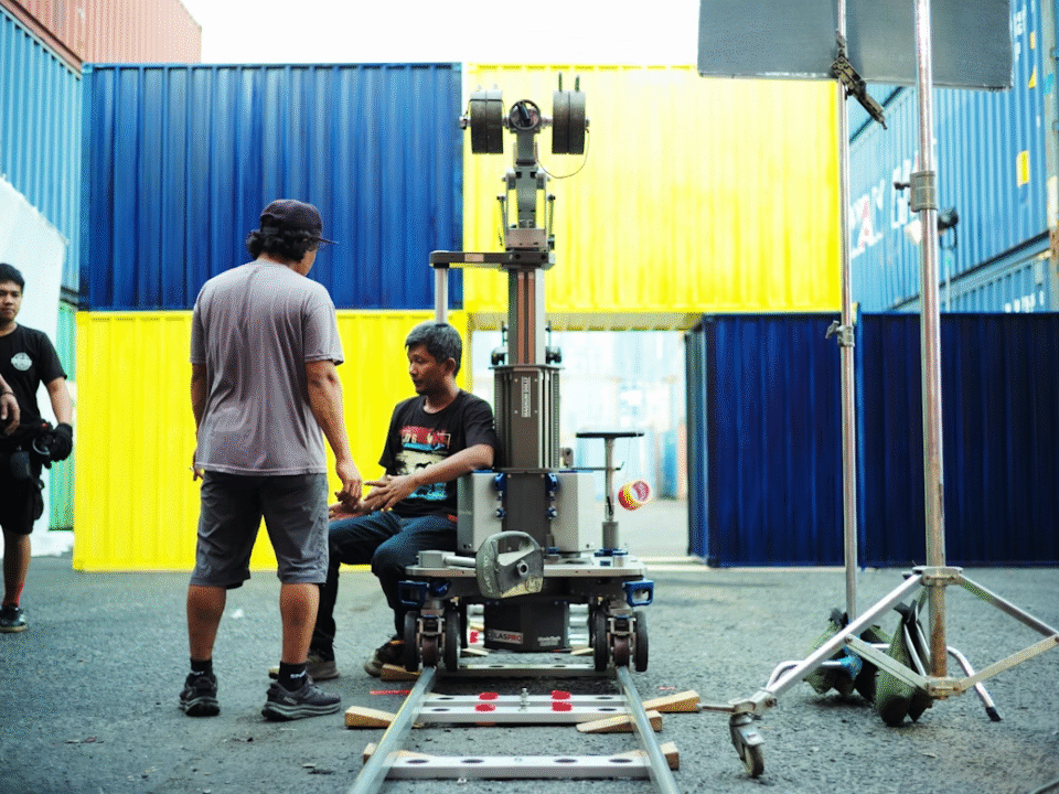 metal containers and people working with heavy machinery