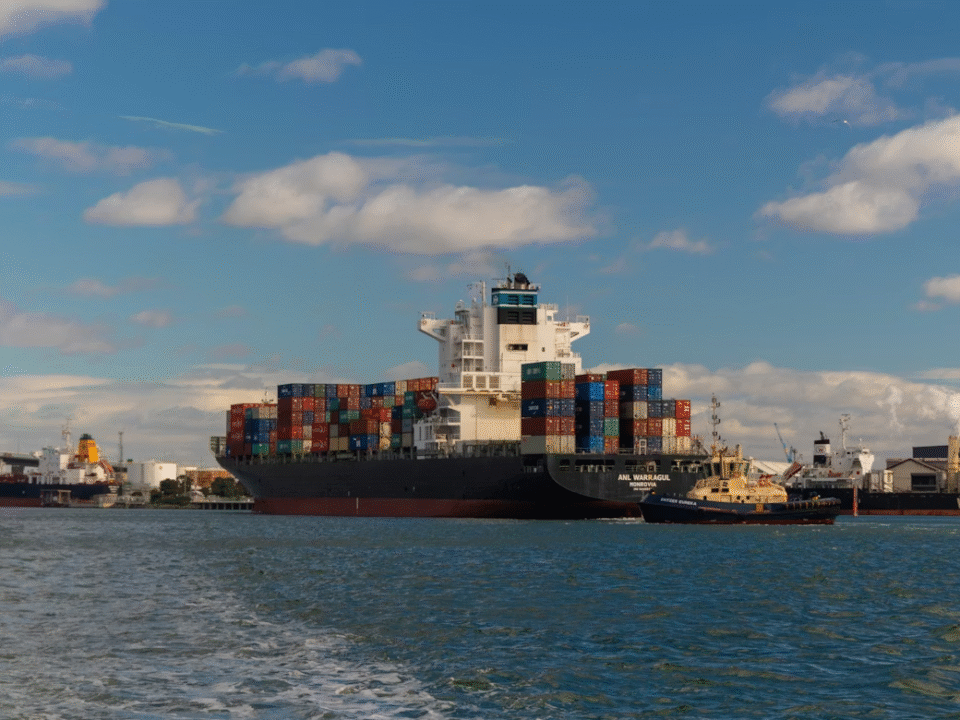 very big ship docked in the port with metal containers